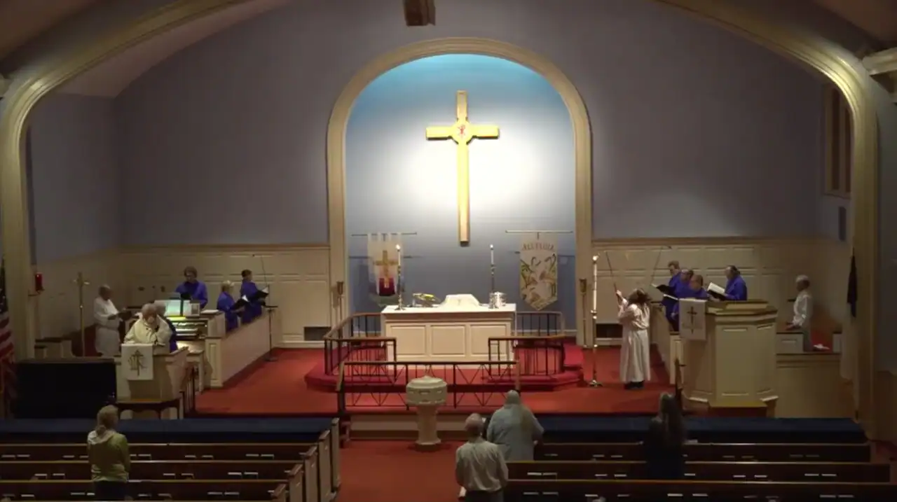 Interior view of Holy Trinity Evangelical Lutheran Church with altar and congregation.